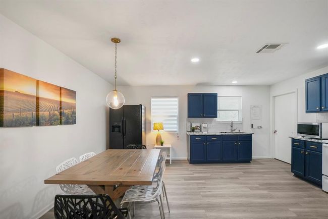 The kitchen and dining area offer a bright, open space with modern updates and plenty of room to gather. | Image 10
