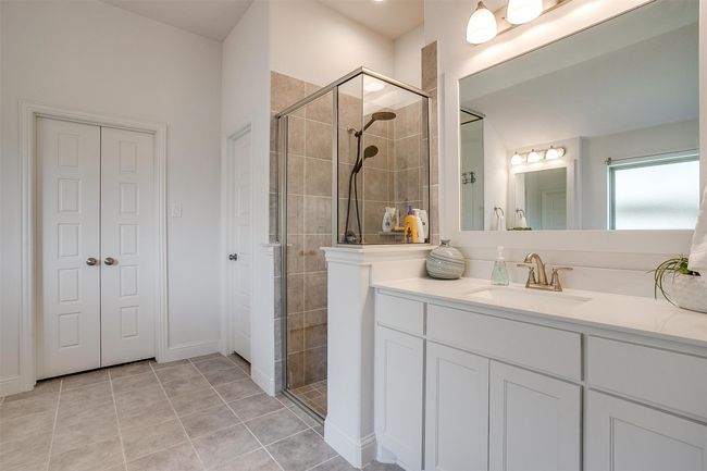Full bath with a stall shower, vanity, and tile patterned flooring | Image 23