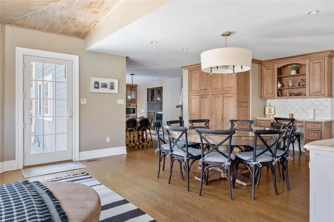 Dining room with recessed lighting, wood finished floors, visible vents, and baseboards | Image 16