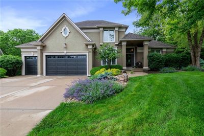 View of front facade with covered porch and a garage | Image 2