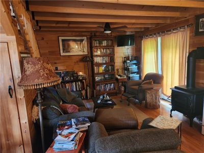 Cozy living room with stove for warmth | Image 2