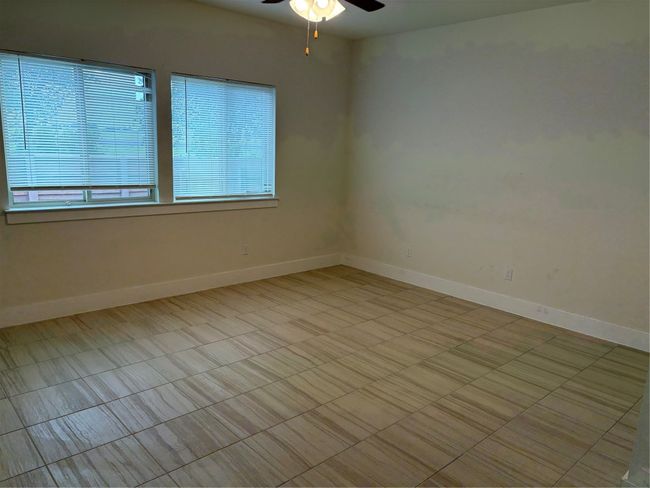 Living room featuring a ceiling fan and baseboards | Image 5