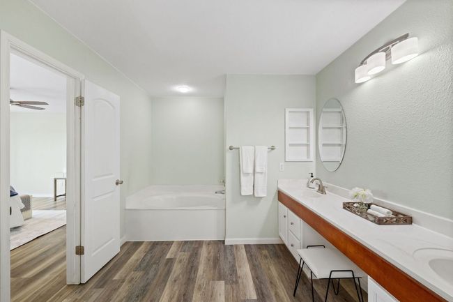 Bathroom with double vanity, a bath, wood finished floors, and ensuite bathroom | Image 33