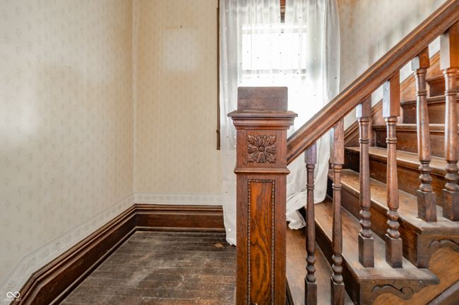 stairs featuring wallpapered walls and wood finished floors | Image 5