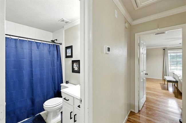 Charming secondary bathroom features a tub/shower combo with tile surround, updated vanity with storage, and fresh neutral finishes. Conveniently located to serve all upstairs secondary bedrooms. | Image 18