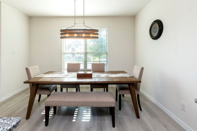 Dining space with baseboards and light wood finished floors | Image 7