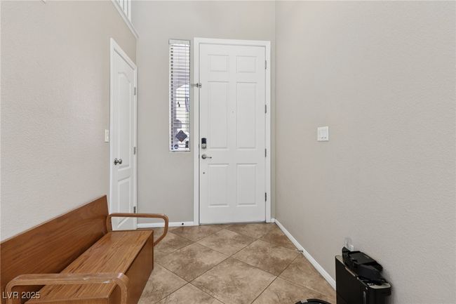 Entryway with light tile patterned floors and baseboards | Image 6
