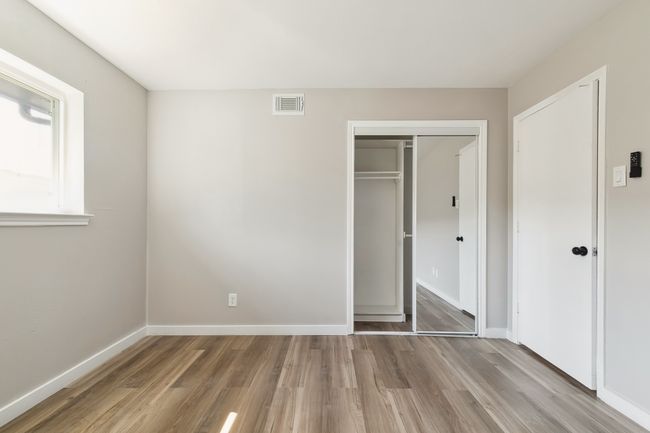 Unfurnished bedroom with a closet, visible vents, baseboards, and light wood-type flooring | Image 24