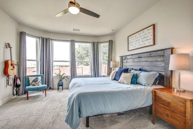 Bedroom featuring carpet, multiple windows, and a ceiling fan | Image 15