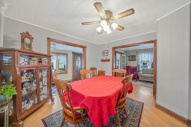 Dining room featuring ceiling fan, light wood-type flooring, and a wealth of natural light | Image 8