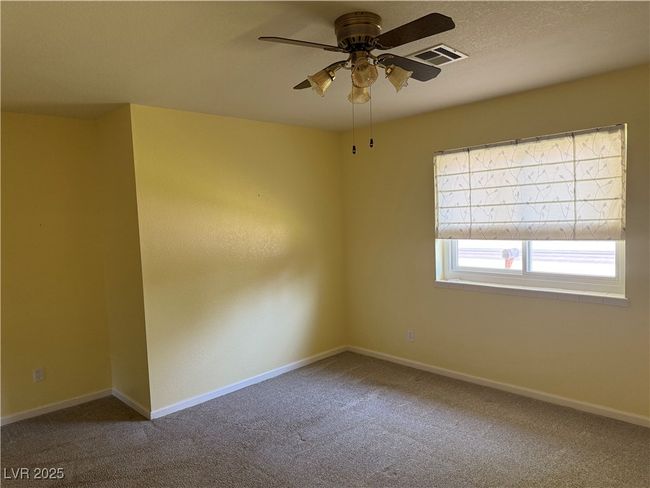 Empty room featuring carpet floors, a ceiling fan, and baseboards | Image 22