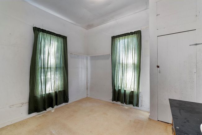 Carpeted empty room featuring a wealth of natural light | Image 15