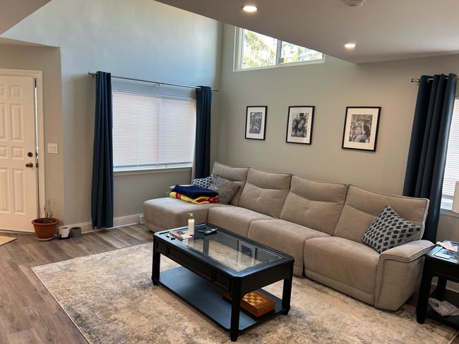 Living area with wood finished floors, recessed lighting, baseboards, and high vaulted ceiling | Image 21