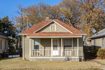 Bungalow-style home featuring a porch and a front yard | Image 1