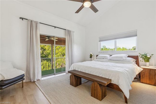 Bedroom with multiple windows, light wood finished floors, ceiling fan, and access to exterior | Image 20