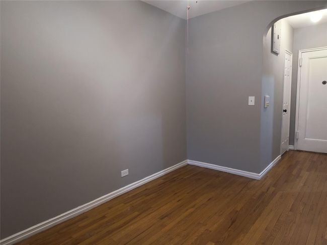 Unfurnished room with baseboards, arched walkways, and dark wood finished floors | Image 11