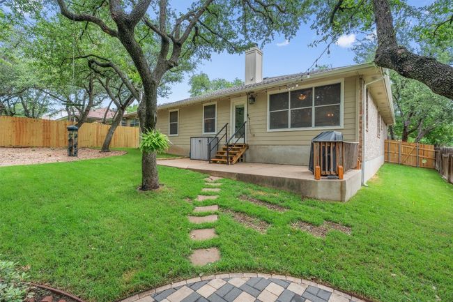 Back of property featuring a chimney, a patio, a fenced backyard, and entry steps | Image 35