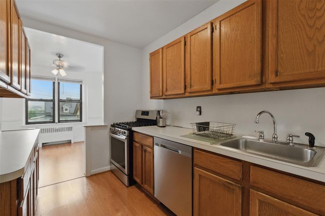 Kitchen flows into dining room. | Image 8
