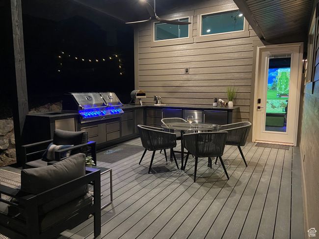 Wooden deck with a grill and outdoor dining space | Image 72