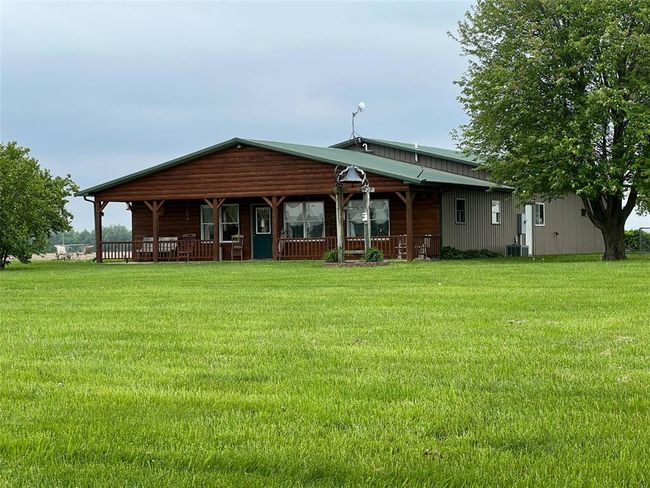 View of front of property with covered porch, a front yard, and cooling unit | Image 26
