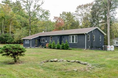 View of front of property with cooling unit and a front lawn | Image 1