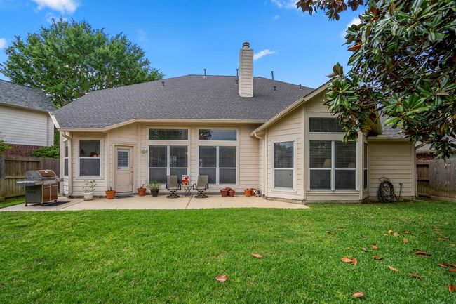 Another view of the back of the home showcases the spacious patio and provides a clear perspective of the home's layout and design, offering plenty of room for outdoor enjoyment. | Image 36