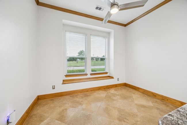 Breakfast area with ornamental molding, ceiling fan, and breakfast​​‌​​​​‌​​‌‌​‌‌​​​‌‌​​‌‌​‌​​​​​‌ bar | Image 13