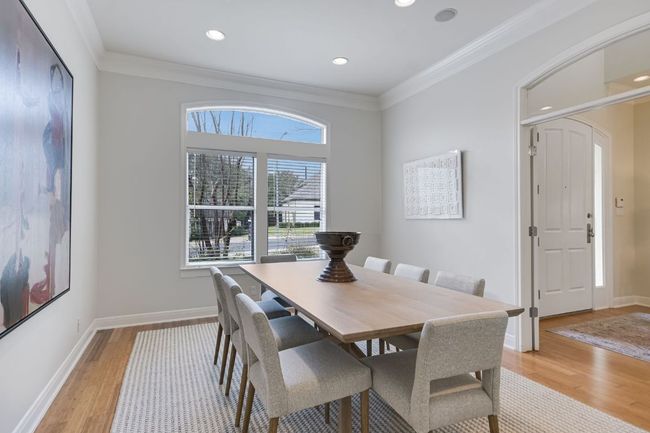Dining area with room for a large dining table, crown molding, high ceilings and recessed lighting. | Image 6