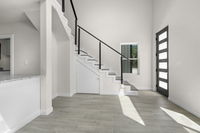 Entrance foyer featuring a high ceiling and stairway | Image 4