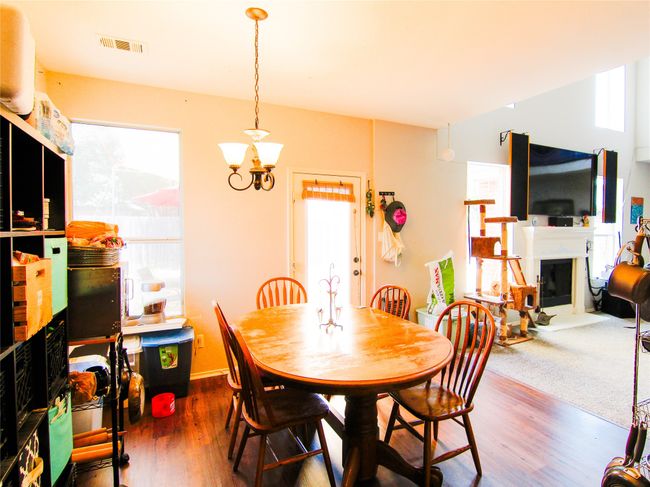 Dining area featuring healthy amount of natural light, a fireplace, and wood finished floors | Image 4