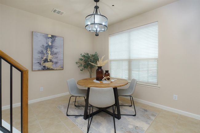 Dining area with visible vents, baseboards, a notable chandelier, and light tile patterned floors | Image 7