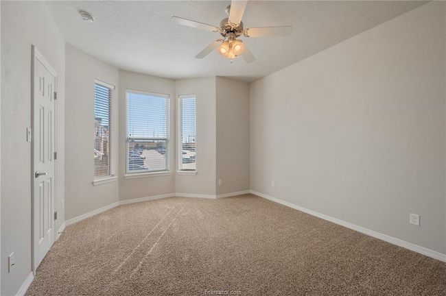 Empty room featuring a ceiling fan, baseboards, and light colored carpet | Image 22