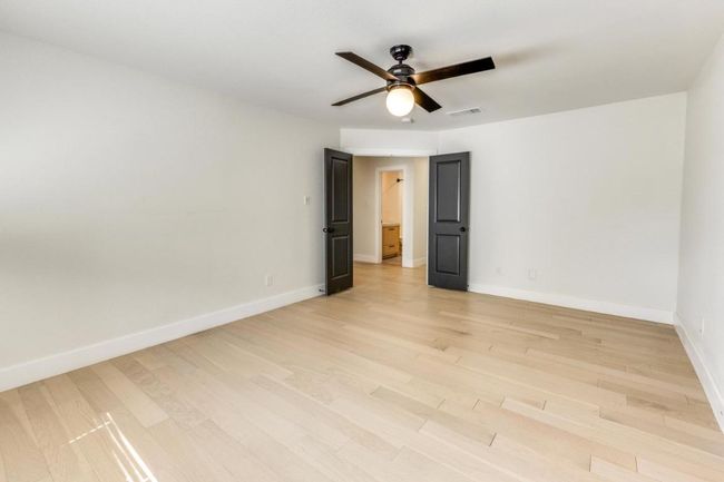 Empty room featuring baseboards, visible vents, a ceiling fan, and light wood-style flooring | Image 20