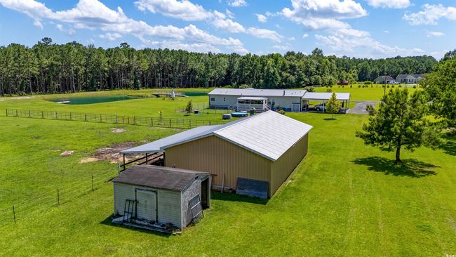 Aerial view of property and surrounding area with a nearby body of water and a heavily wooded area | Image 10