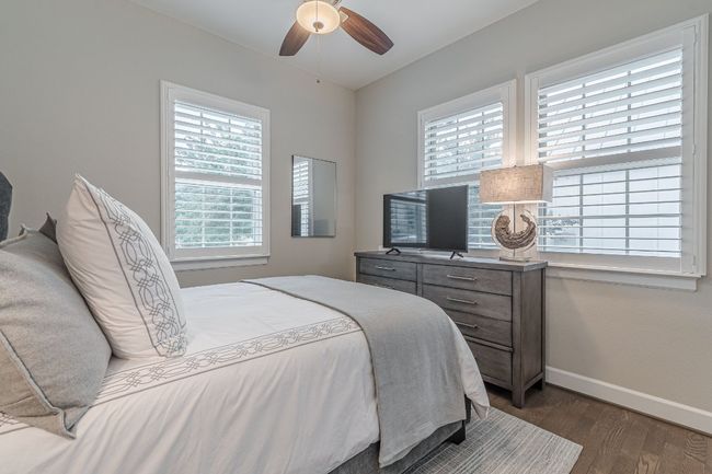 Bedroom with multiple windows, wood finished floors, and baseboards | Image 21