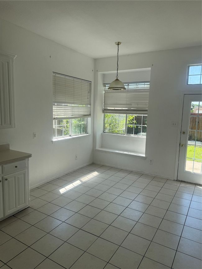 Unfurnished dining area with light tile patterned flooring | Image 9
