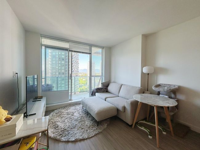 Living area with wood finished floors | Image 7