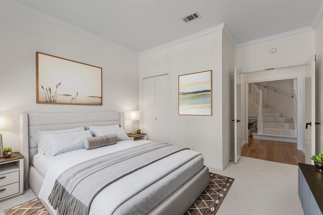 Bedroom with crown molding, baseboards, and light colored carpet | Image 15