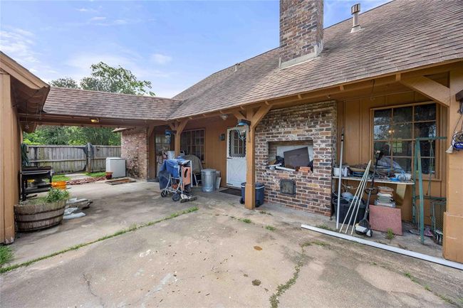 Home offers a covered walk from the pool house/garage to the back door. | Image 23