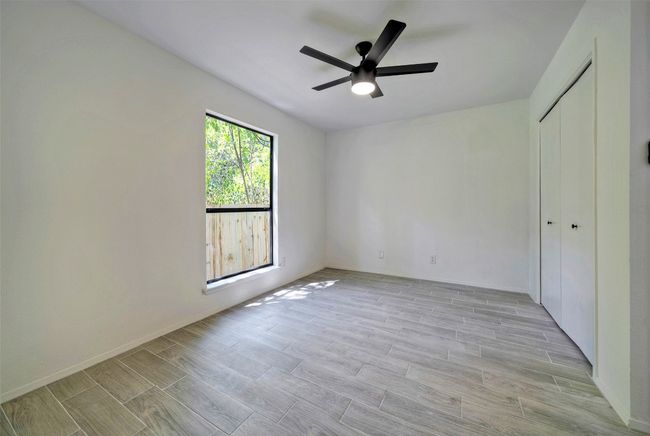 Unfurnished bedroom featuring light wood-style flooring, a closet, and ceiling fan | Image 14