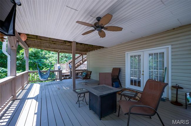 Wooden terrace featuring stairs, french doors, and a ceiling fan | Image 51