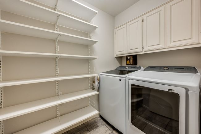 Laundry room with built-in cabinets and extended shelving | Image 31