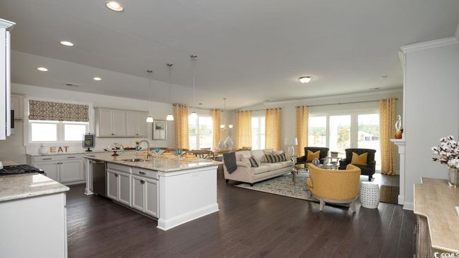 Kitchen with light stone countertops, dark wood finished floors, a healthy amount of sunlight, and a sink | Image 5