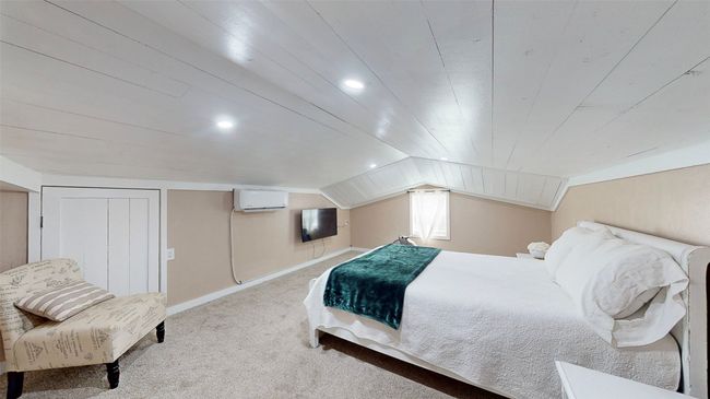 Bedroom featuring carpet and lofted ceiling | Image 18