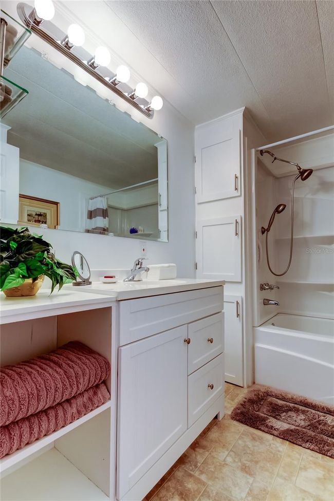 10. FULLY UPDATEDGuest Bathroom (8.8' x 6.5') Tub w Multiple Shelves, Oversized Vanity w Open & Hidden Storage, & 3 Deep Storage Cabinets!! | Image 10