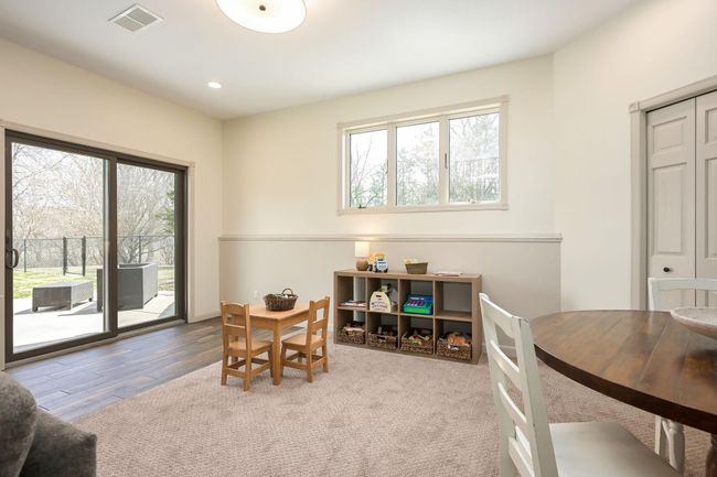 Lower level also features the high ceilings - 9-foot! In front of sliding door, you'll appreciate the extra deep tile floors. | Image 32