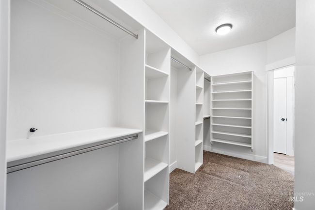 Walk in closet featuring carpet floors | Image 18