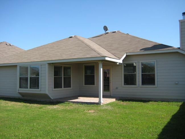 Back of property with a chimney, a patio area, a yard, and roof with shingles | Image 12