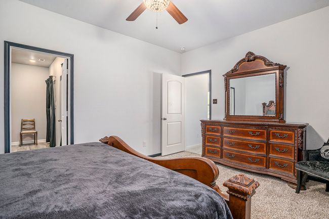 Primary Bedroom with baseboards, ceiling fan, and carpet | Image 15