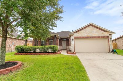 Welcome to your new home. Brick and stone exterior with a covered front porch. | Image 1